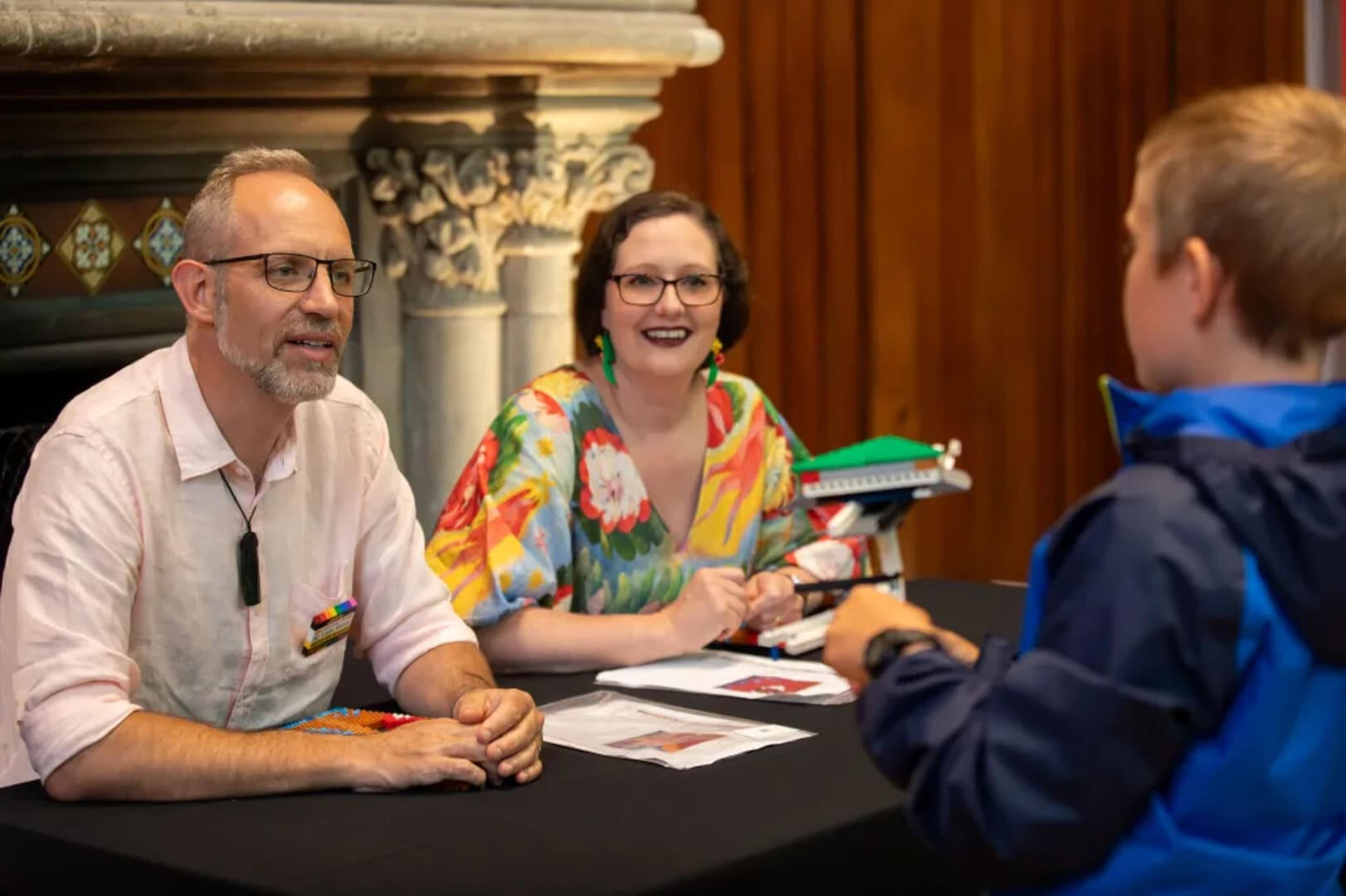 Lego Masters NZ winners and creators of Bricks of Olympus Jake Roos and Emily Fryer talking with exhibition attendees at Teece